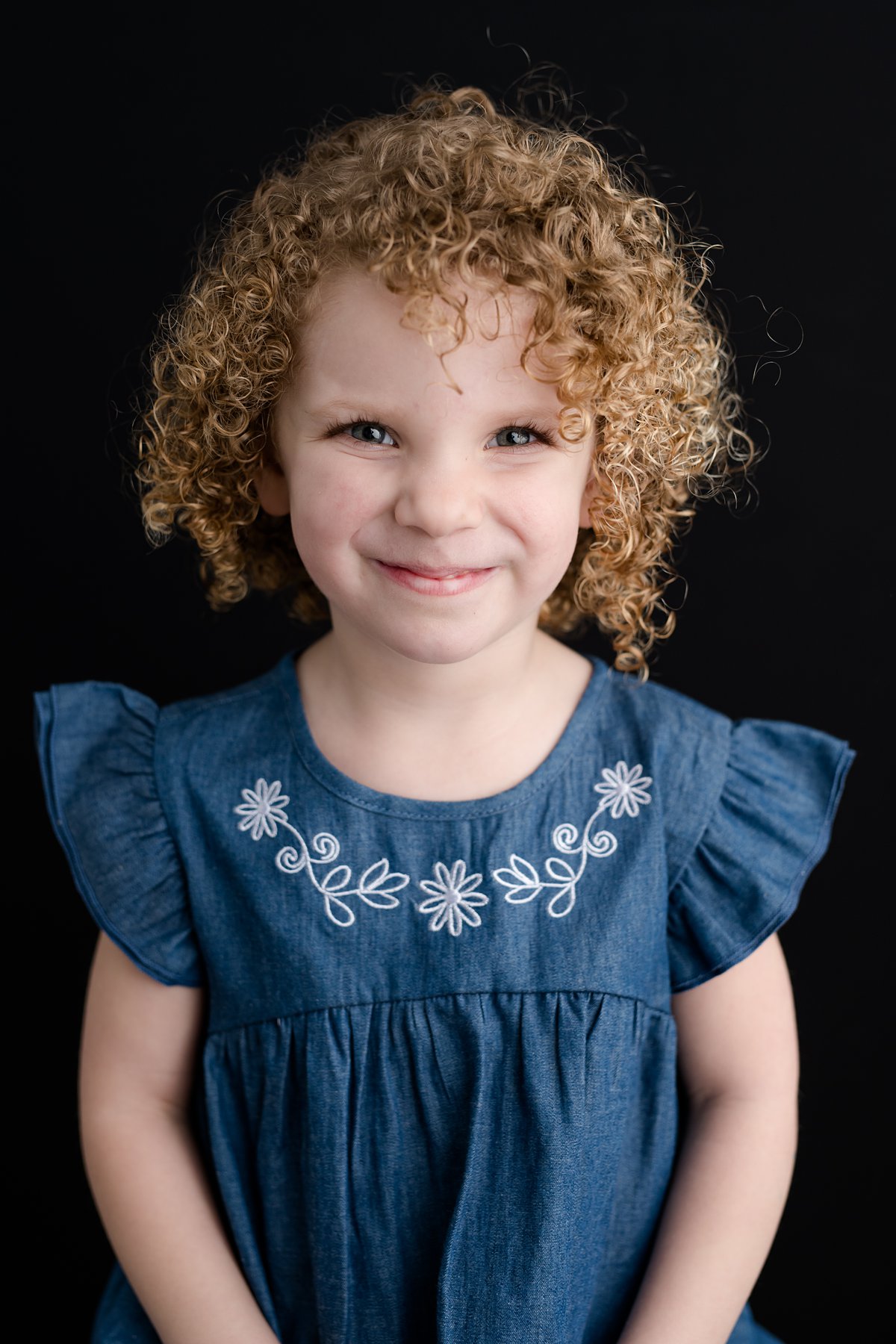 curly haired smiling girl