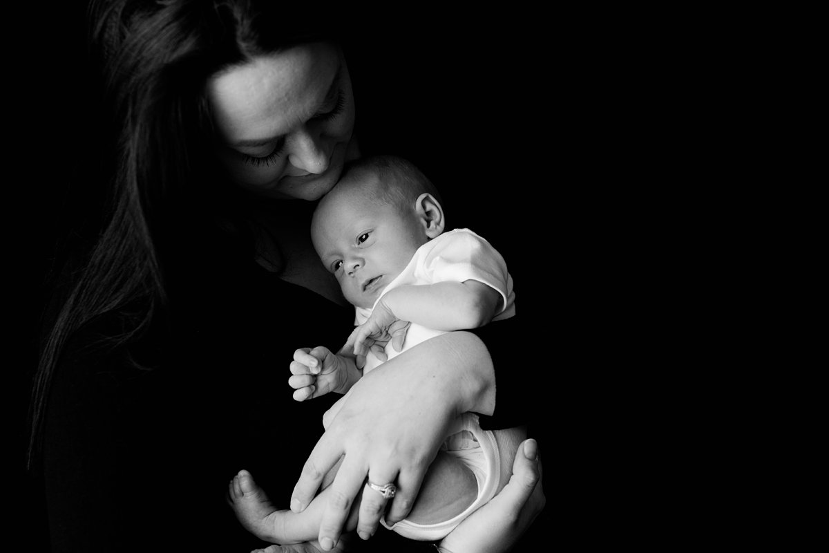 black and white image of mom with newborn