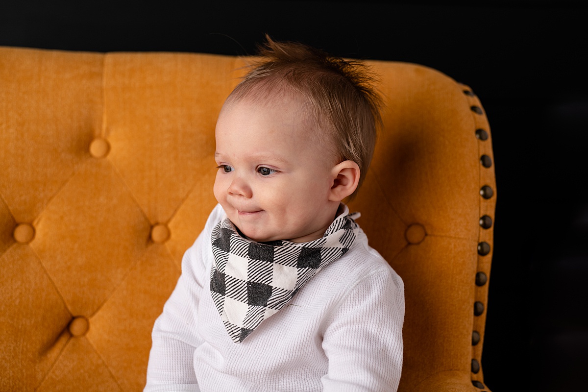 toddler in yellow chair with black background, mitchell sd studio